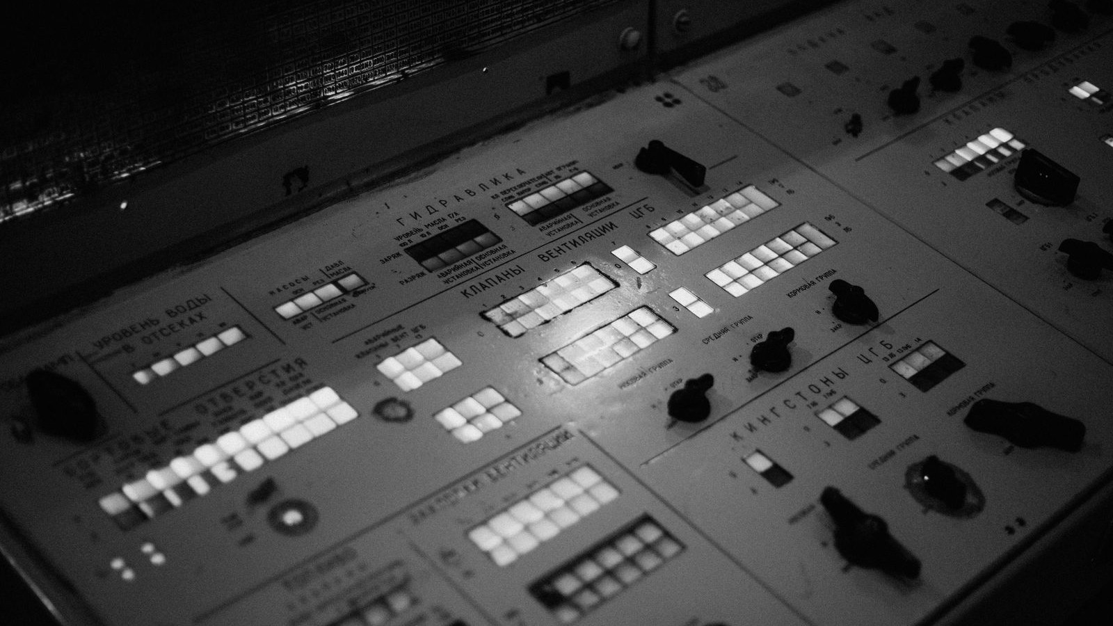 A control panel of switches and rows of indicator lights.