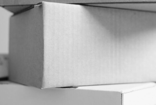Plain finished mailer boxes stacked on a counter