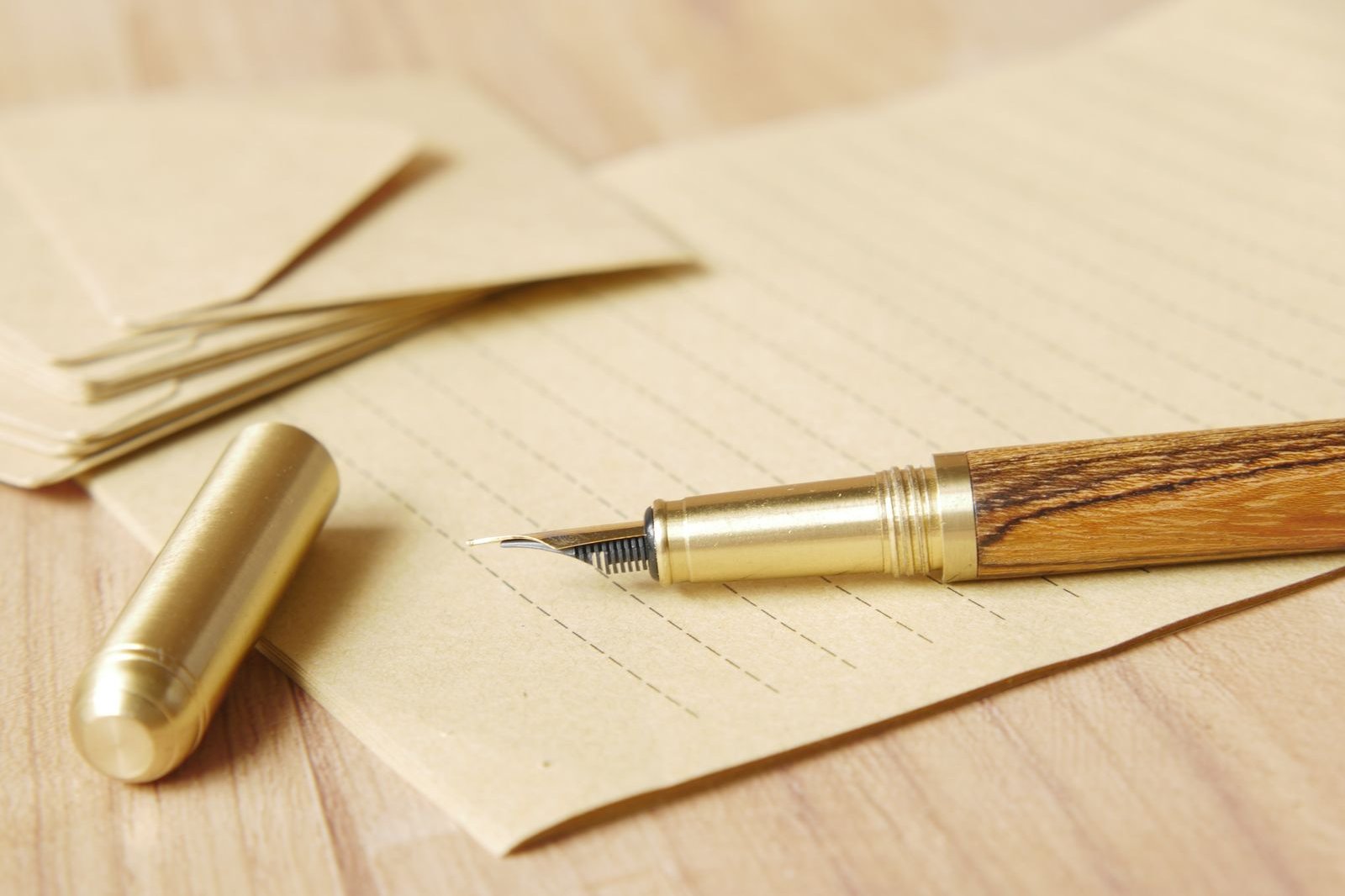 A fountain pen resting on a blank lined page