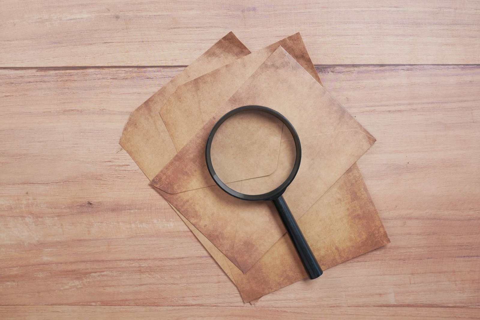 A magnifying glass resting on blank paper