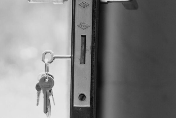 A door standing open with keys still in the lock