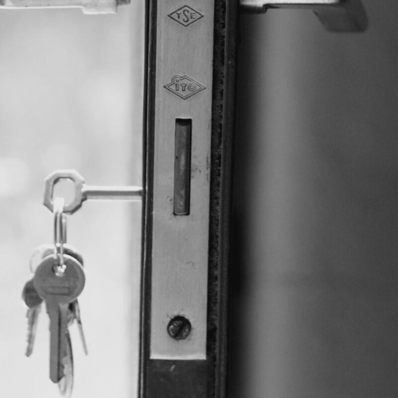 A door standing open with keys still in the lock
