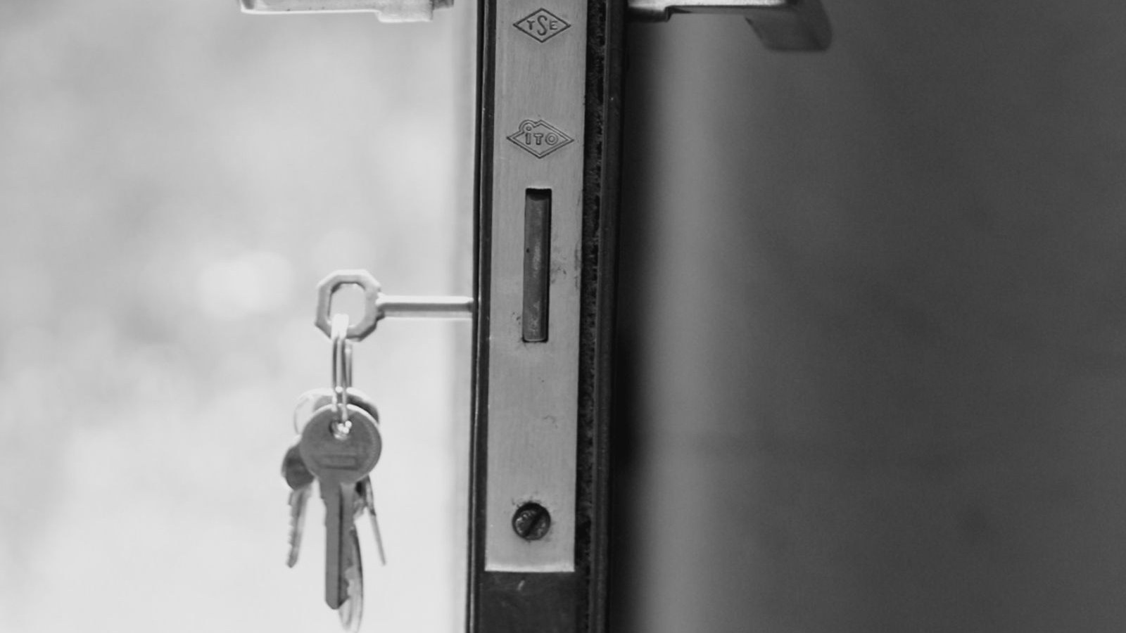 A door standing open with keys still in the lock