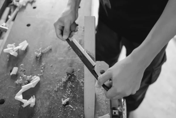 Build vs buy AI decision, woodworker shaping a piece by hand