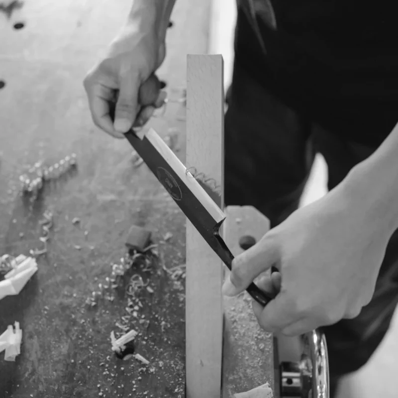 Build vs buy AI decision, woodworker shaping a piece by hand